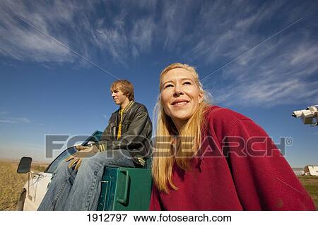 two people sit on the back of a truck; three hills, alberta, canada View Large Photo Image Stock Photo - two people sit on the back of a truck; three hills, alberta, canada. Fotosearch