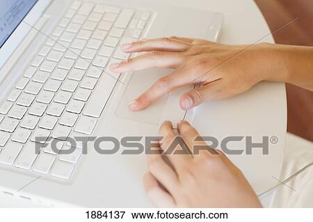 using a white laptop computer on a table; benalamadena costa, malaga, andalusia, spain View Large Photo Image Stock Photo - using a white laptop computer on a table; benalamadena costa, malaga, andalusia, spain. Fotosearch