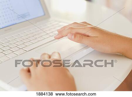 using a white laptop computer on a table; benalamadena costa, malaga, andalusia, spain View Large Photo Image Stock Photo - using a white laptop computer on a table; benalamadena costa, malaga, andalusia, spain. Fotosearch