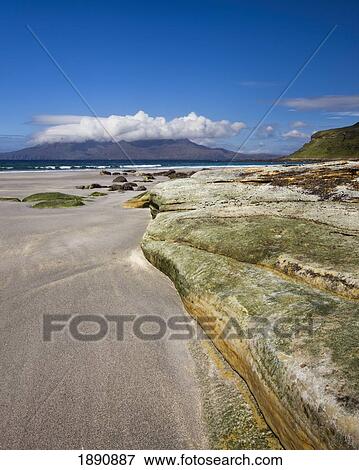 Stock Photo - view across the sound of rum from the singing sands; eisle of eigg, lochaber, highlands, scotland. Fotosearch