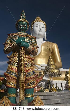 wat doi kham temple statue with guardian giant; chiang mai, thailand View Large Photo Image Stock Image - wat doi kham temple statue with guardian giant; chiang mai, thailand. Fotosearch