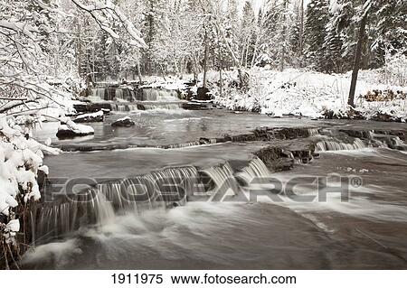 Stock Photography - waterfall with fresh snow; thunder bay, ontario, canada. Fotosearch