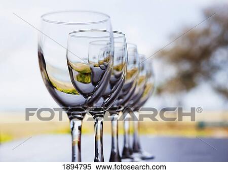 wine glasses in a row View Large Photo Image Stock Photography - wine glasses in a row. Fotosearch