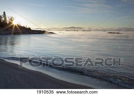 winter mist on lake superior at sunrise; terrace bay, ontario, canada View Large Photo Image Stock Photography - winter mist on lake superior at sunrise; terrace bay, ontario, canada. Fotosearch