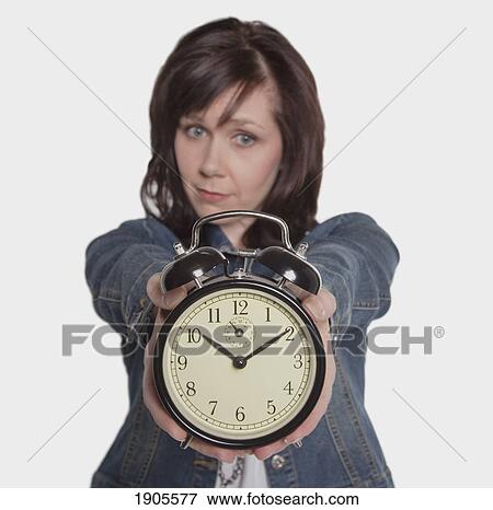 Stock Photo - woman focusing on the time. Fotosearch