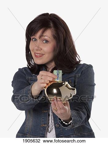 woman saving money in a piggy bank; edmonton, alberta, canada View Large Photo Image Stock Image - woman saving money in a piggy bank; edmonton, alberta, canada. Fotosearch