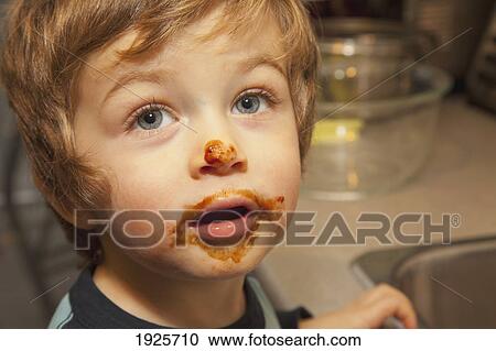 Stock Image - a boy with a messy face; langley, british columbia, canada. Fotosearch