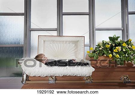 Stock Image - a boy's body laying in a coffin. Fotosearch