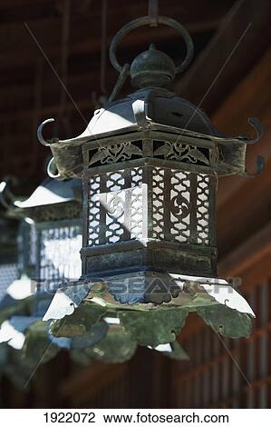 a hanging lantern at kasuga-taisha shrine; nara, nara prefecture, japan View Large Photo Image Stock Image - a hanging lantern at kasuga-taisha shrine; nara, nara prefecture, japan. Fotosearch