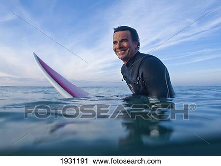 a man in the water with his surfboard at bunker beach; tarifa, cadiz, andalusia, spain View Large Photo Image Stock Image - a man in the water with his surfboard at bunker beach; tarifa, cadiz, andalusia, spain. Fotosearch