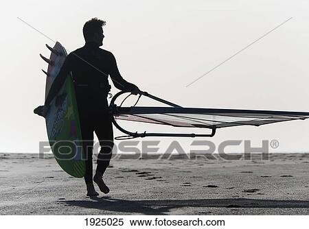 a man walking on the beach carrying a kite surfboard; tarifa, cadiz, andalusia, spain View Large Photo Image Stock Photography - a man walking on the beach carrying a kite surfboard; tarifa, cadiz, andalusia, spain. Fotosearch