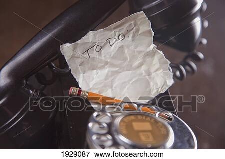 Stock Photo - a 'to do' list sitting on an antique telephone. Fotosearch