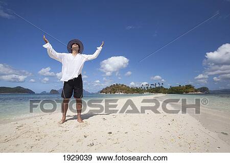 a tourist stands on the pure white sands of snake island, near el nido; bacuit archipelago, palawan, philippines View Large Photo Image Stock Photo - a tourist stands on the pure white sands of snake island, near el nido; bacuit archipelago, palawan, philippines. Fotosearch