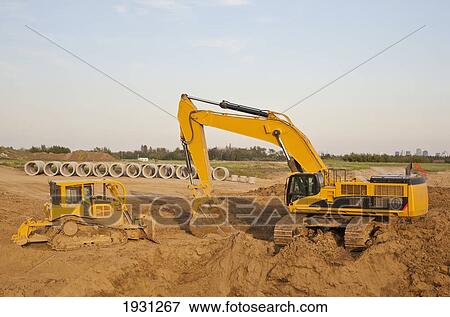Stock Photo - backhoe digging for sewer installation; st. albert, alberta, canada. Fotosearch