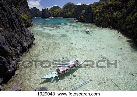 bangka boats in the small lagoon on miniloc island, near el nido; bacuit archipelago, palawan, philippines View Large Photo Image Stock Photo - bangka boats in the small lagoon on miniloc island, near el nido; bacuit archipelago, palawan, philippines. Fotosearch