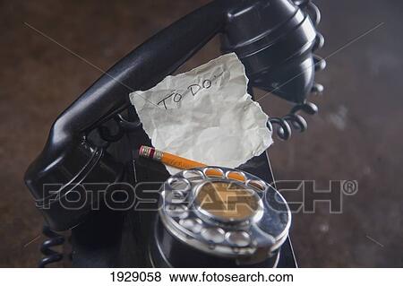 Stock Photo - close-up of antique telephone with pencil and 'to do' list. Fotosearch