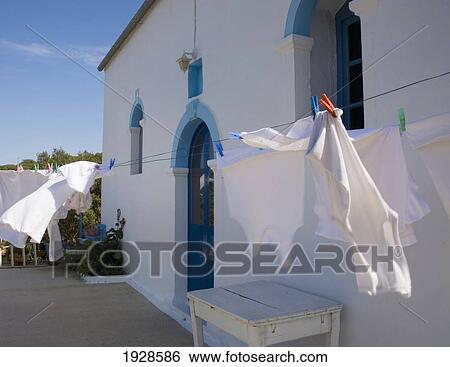 Stock Photograph - clothing on a clothes line at kioni church; ithaki, greece. Fotosearch