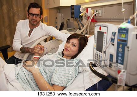 Stock Image - couple expecting baby in maternity ward. Fotosearch