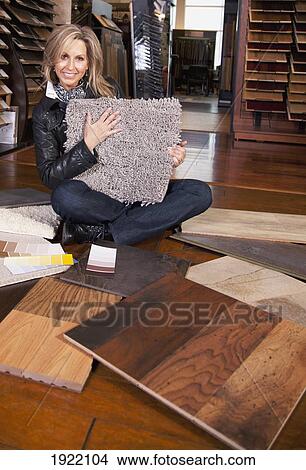 Picture - customer choosing floor coverings in a retail floor establishment; edmonton, alberta, canada. Fotosearch