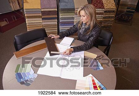 Picture - customer choosing floor coverings in a retail flooring store; edmonton, alberta, canada. Fotosearch