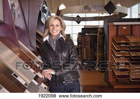 Stock Photo - customer choosing floor coverings in a retail floor establishment; edmonton, alberta, canada. Fotosearch