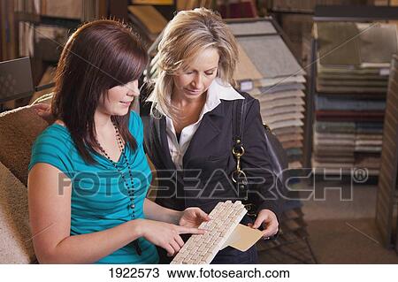 Stock Image - design consultant assisting a customer in a retail flooring store; edmonton, alberta, canada. Fotosearch