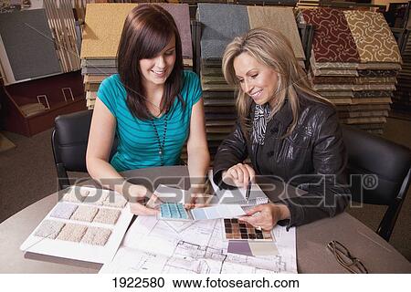 Stock Image - design consultant assisting a customer in a retail flooring store; edmonton, alberta, canada. Fotosearch