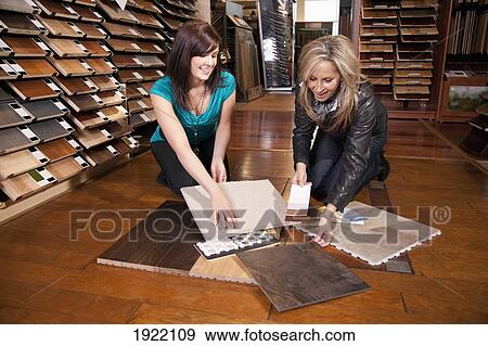 design consultant assisting a customer in a retail flooring store; edmonton, alberta, canada View Large Photo Image Stock Photo - design consultant assisting a customer in a retail flooring store; edmonton, alberta, canada. Fotosearch