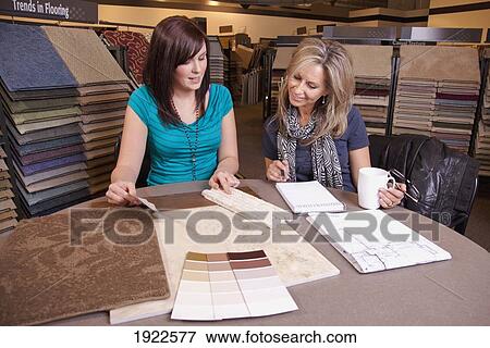 design consultant assisting a customer in a retail flooring store; edmonton, alberta, canada View Large Photo Image Stock Photo - design consultant assisting a customer in a retail flooring store; edmonton, alberta, canada. Fotosearch