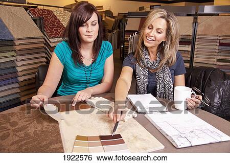 Stock Photograph - design consultant assisting a customer in a retail flooring store; edmonton, alberta, canada. Fotosearch