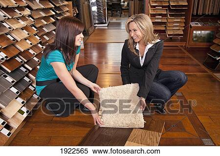 Stock Photography - design consultant assisting a customer in a retail flooring store; edmonton, alberta, canada. Fotosearch