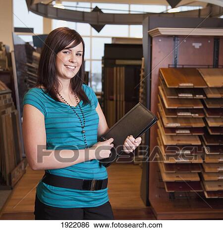 Stock Photograph - design consultant in a retail flooring store; edmonton, alberta, canada. Fotosearch