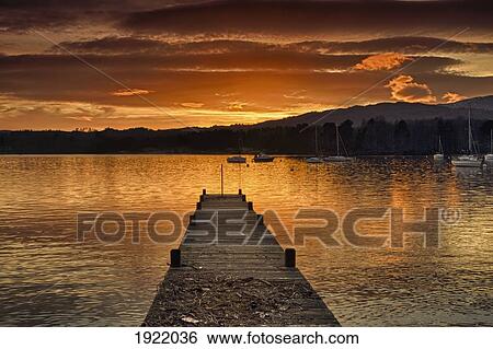 Stock Photograph - dock on lake windermere at sunset; ambleside, cumbria, england. Fotosearch