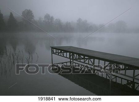Stock Image - dock with fog over lake; rekowo, koszalin county, poland. Fotosearch