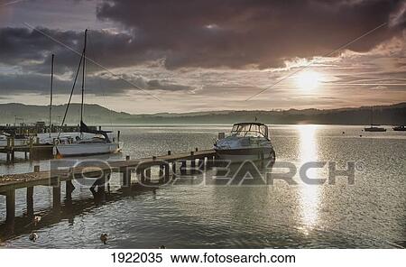 docked boat on lake windermere at sunset; ambleside, cumbria, england View Large Photo Image Stock Photography - docked boat on lake windermere at sunset; ambleside, cumbria, england. Fotosearch