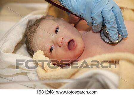 doctor checking newborn baby girl; edmonton, alberta, canada View Large Photo Image Stock Photo - doctor checking newborn baby girl; edmonton, alberta, canada. Fotosearch