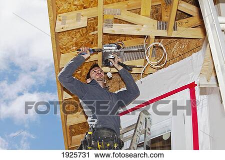 electrician installing light fixtures; edmonton, alberta, canada View Large Photo Image Stock Image - electrician installing light fixtures; edmonton, alberta, canada. Fotosearch