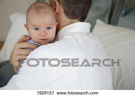 Stock Photo - father holding baby. Fotosearch