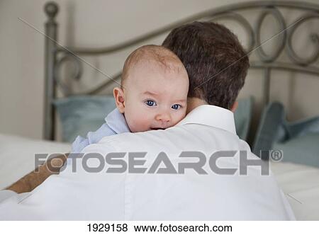 Stock Photo - father holding baby. Fotosearch