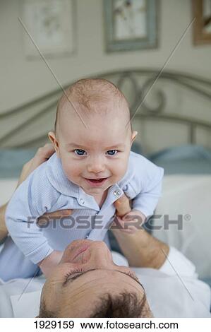 Stock Photo - father holding baby. Fotosearch