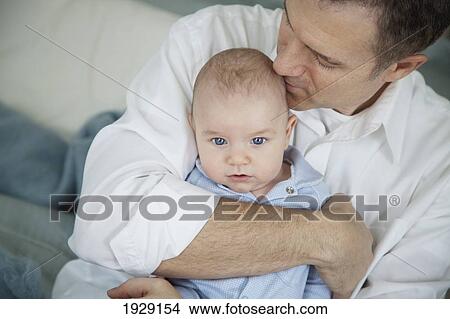 Picture - father hugging baby. Fotosearch