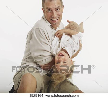 Picture - father playing with his toddler son. Fotosearch