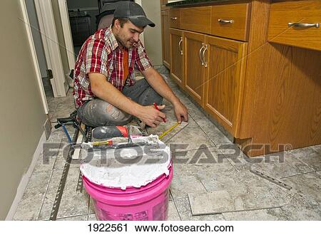 flooring installer working in a bathroom; st. albert, alberta, canada View Large Photo Image Stock Image - flooring installer working in a bathroom; st. albert, alberta, canada. Fotosearch