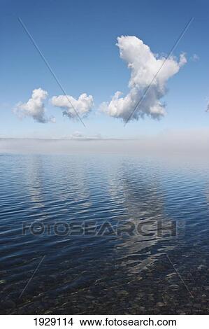 fog clearing from surface of lake to reveal blue water under blue sky; wyoming, united states of america View Large Photo Image Picture - fog clearing from surface of lake to reveal blue water under blue sky; wyoming, united states of america. Fotosearch
