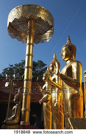 Stock Photo - golden buddhist statues at wat phrathat doi suthep temple; chiang mai, thailand. Fotosearch