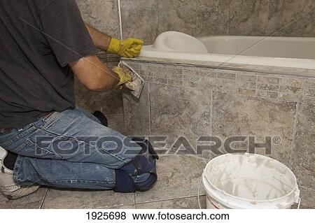 installing tiles for a home renovation; st. albert, alberta, canada View Large Photo Image Stock Photo - installing tiles for a home renovation; st. albert, alberta, canada. Fotosearch