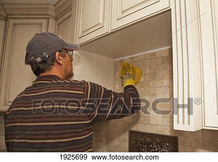 Stock Photo - installing tiles for a home renovation; st. albert, alberta, canada. Fotosearch