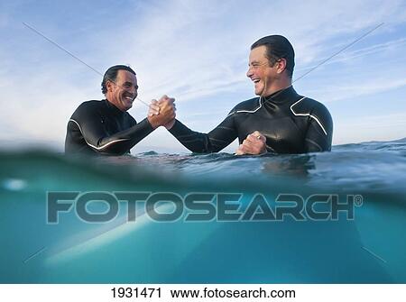 male wakeboarders in the ocean shaking hands; tarifa, cadiz, spain View Large Photo Image Stock Image - male wakeboarders in the ocean shaking hands; tarifa, cadiz, spain. Fotosearch
