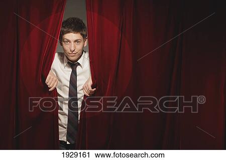 man peeking from behind red stage curtain View Large Photo Image Stock Image - man peeking from behind red stage curtain. Fotosearch