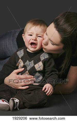 mother consoling her crying baby View Large Photo Image Stock Photograph - mother consoling her crying baby. Fotosearch